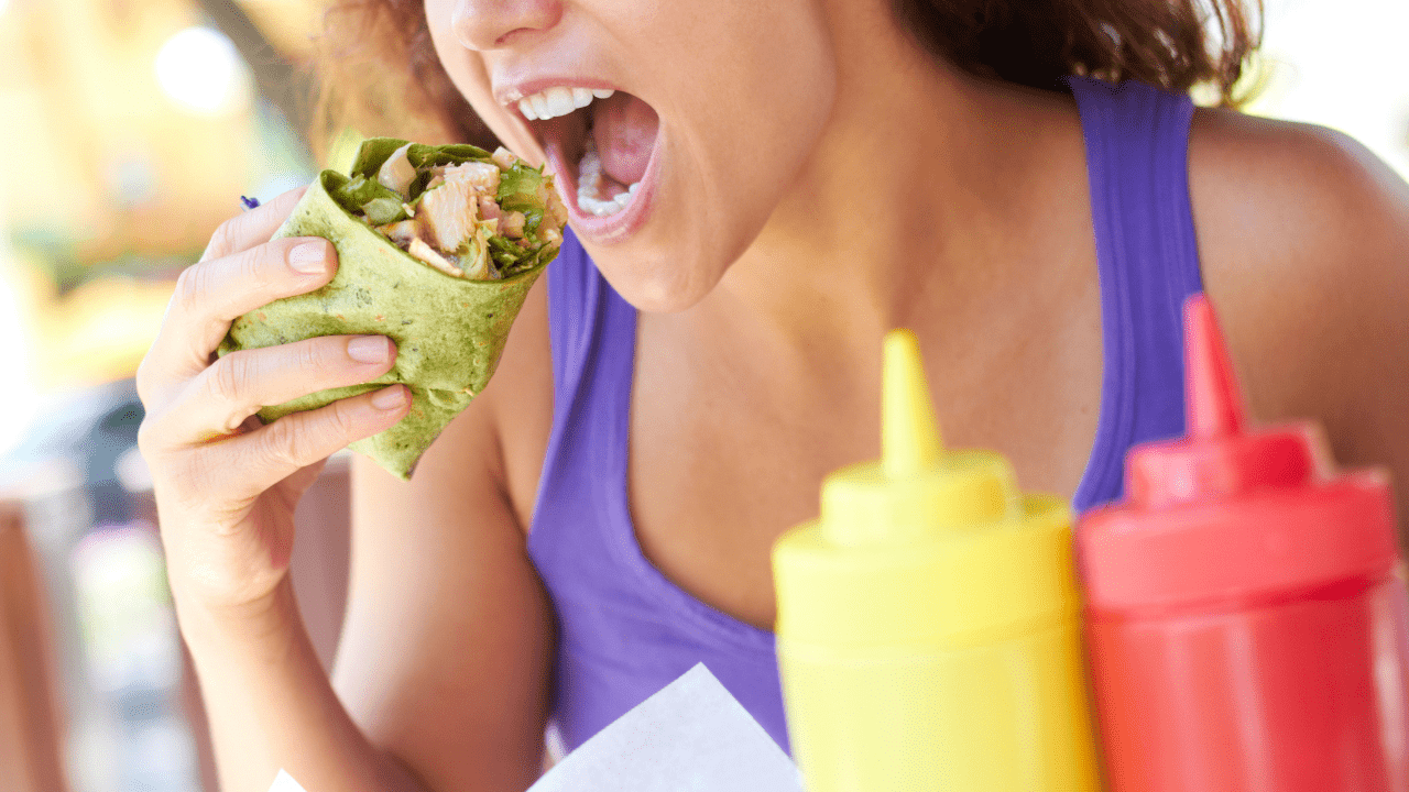 Woman eating chicken wrap | Weight loss Coach and Nutritionist