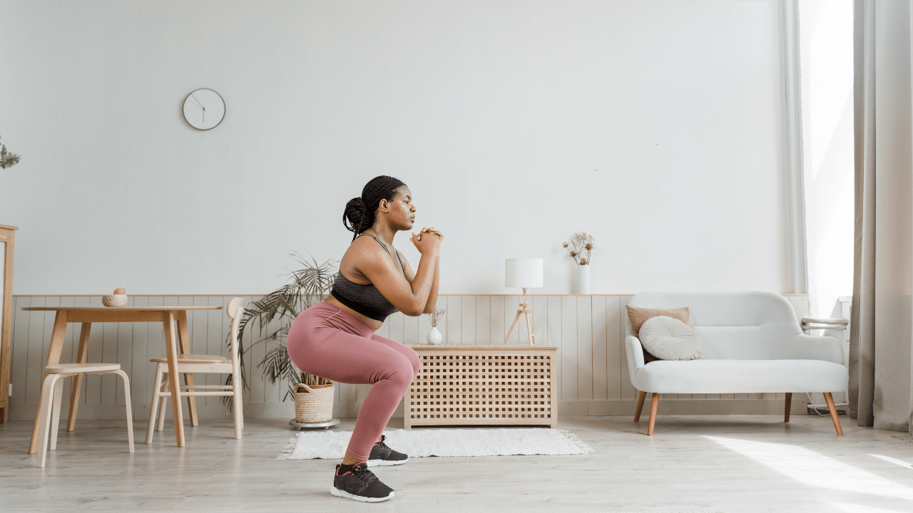 Woman doing squats to lose belly fat after 40