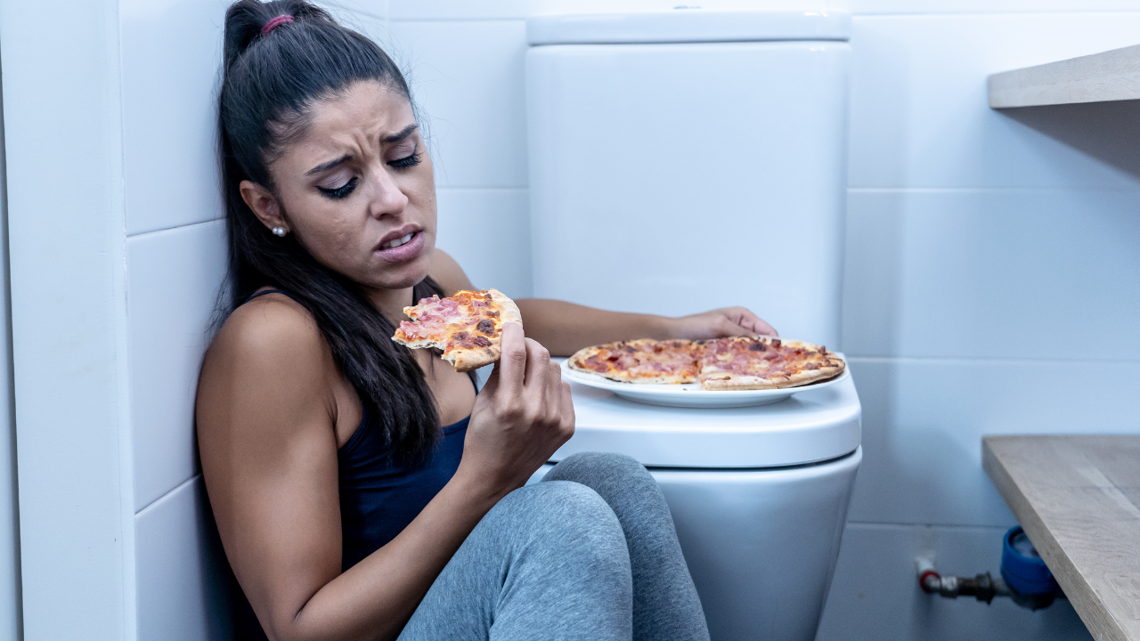 Woman emotional eating in bathroom: Weight Loss Coach and Nutritionist