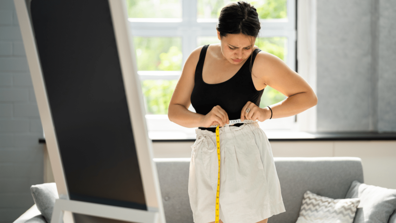Woman Measuring Weight Loss